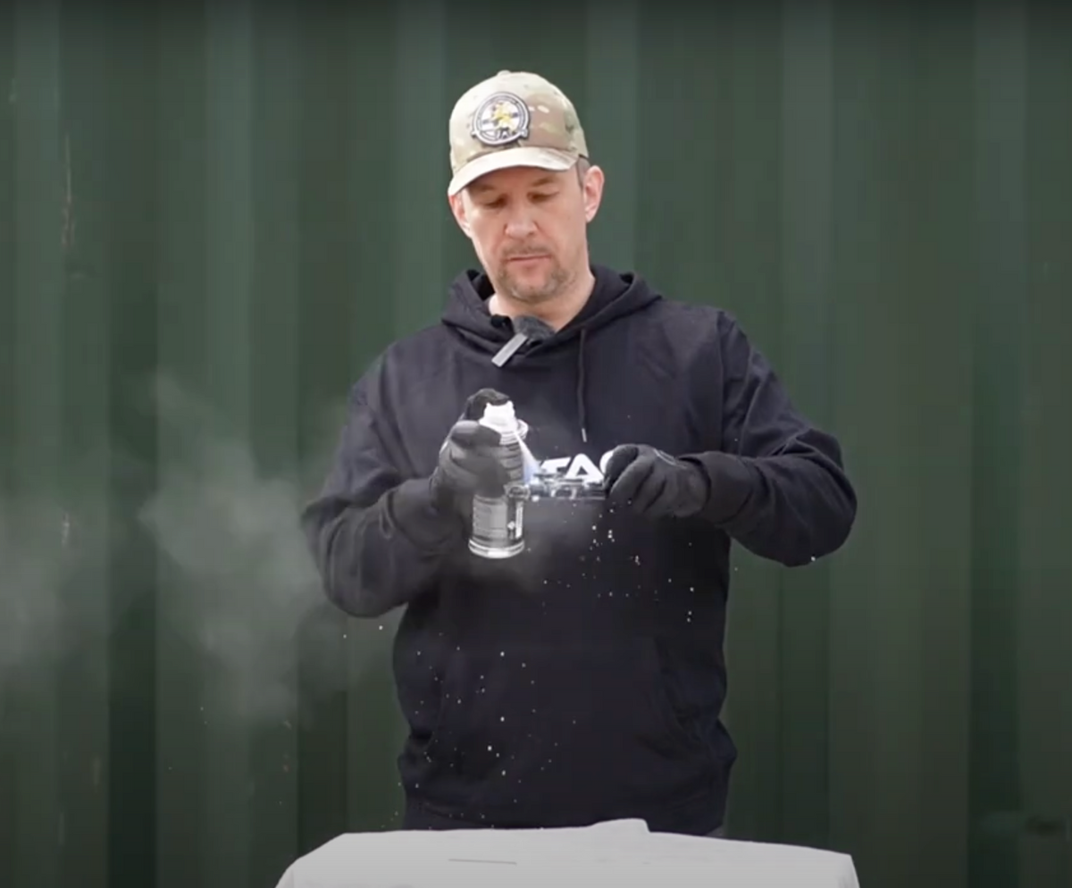 Instructor applying a maintenance product to an AR-15 component