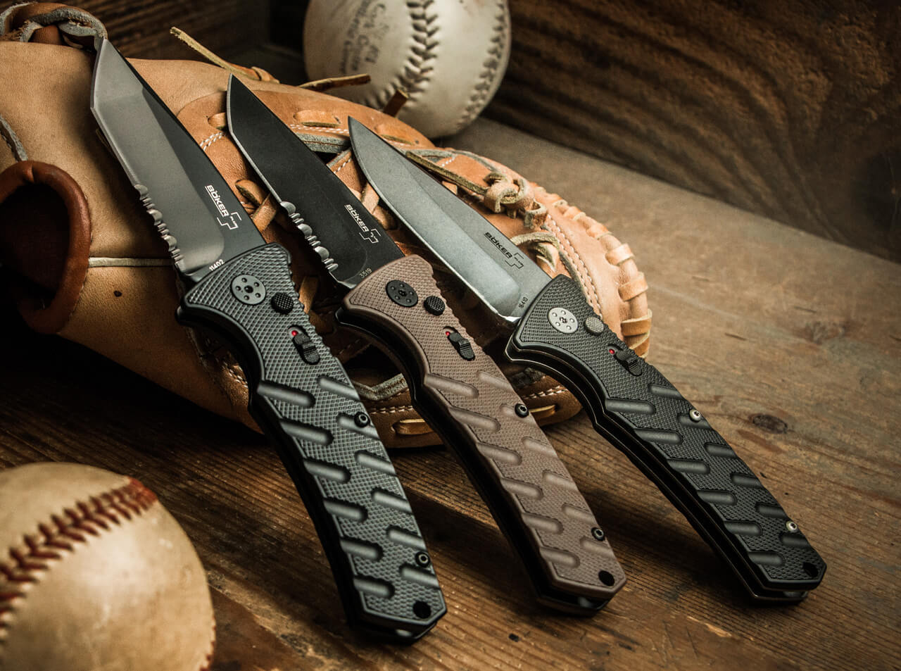 three tactical knives laying on a table
