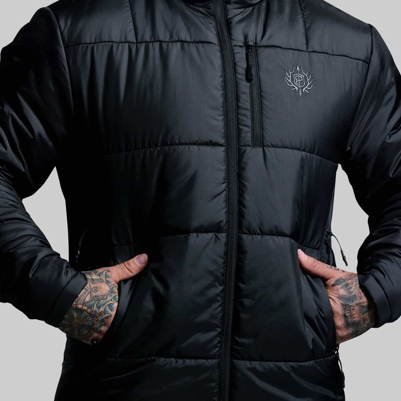 Black puffer jacket with a brand logo on a gray background