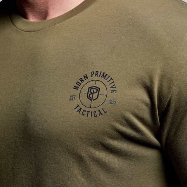Green t-shirt with 'Born Primitive Tactical' logo on a person wearing it.