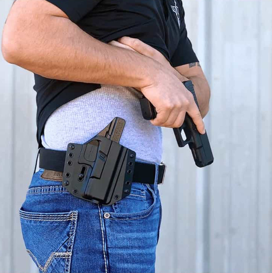 Bravo Concealment OWB Holster For Glock 43, 43X, 43X MOS with glock handgun on male model close up