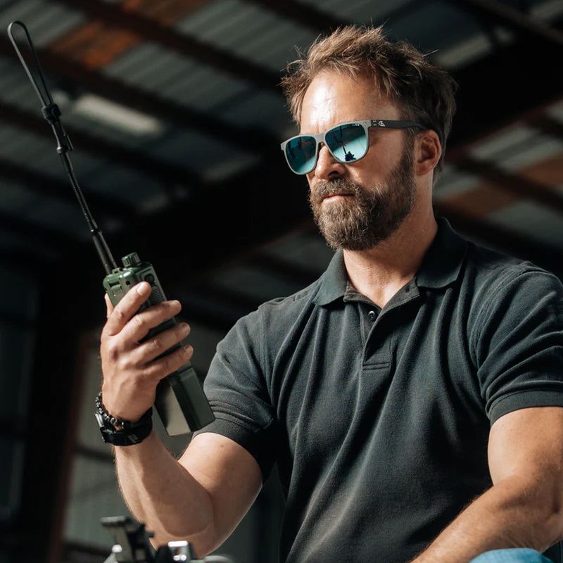 Gatorz Wraith Tactical Eyewear man holding radio