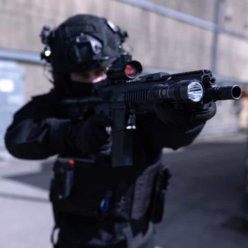 Operator with rifle and mounted Streamlight Protac Rail Mount 1L-X PRO USB weapon light