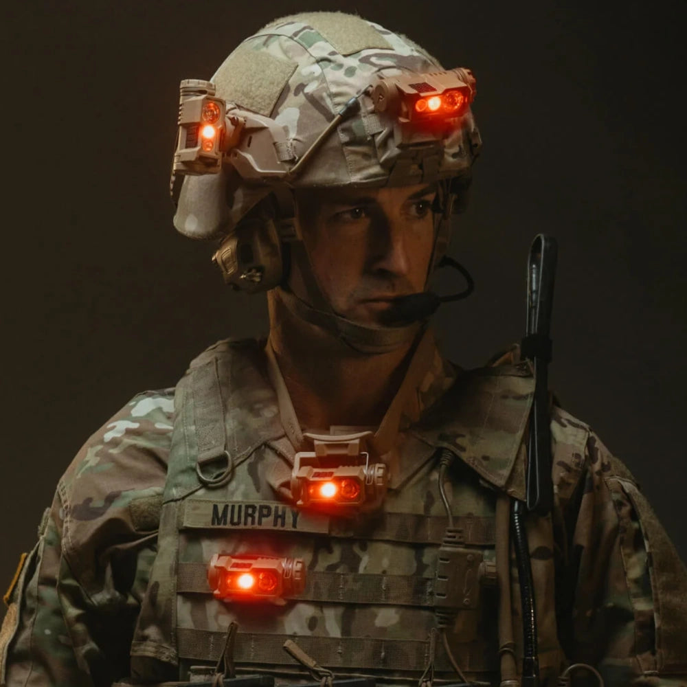 Soldier in camouflage uniform with illuminated Princeton Tec Headlamp Ghost X MPLS 300lm helmet and vest mounts