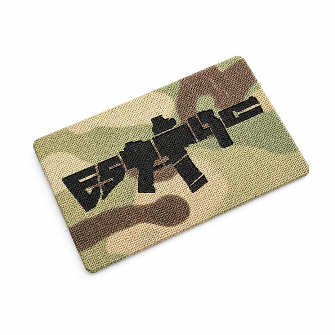 Multicam ESTTAC patch with black graphic design on a white background