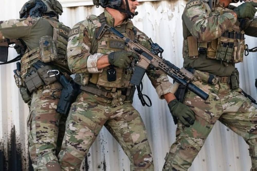3 military men in a tactical situation wearing tactical clothing