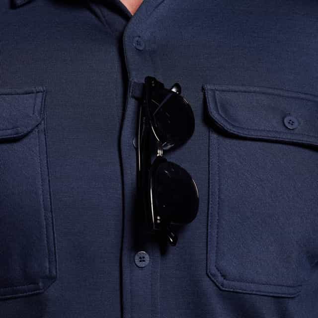 Navy blue coat with sunglasses hanging from a button