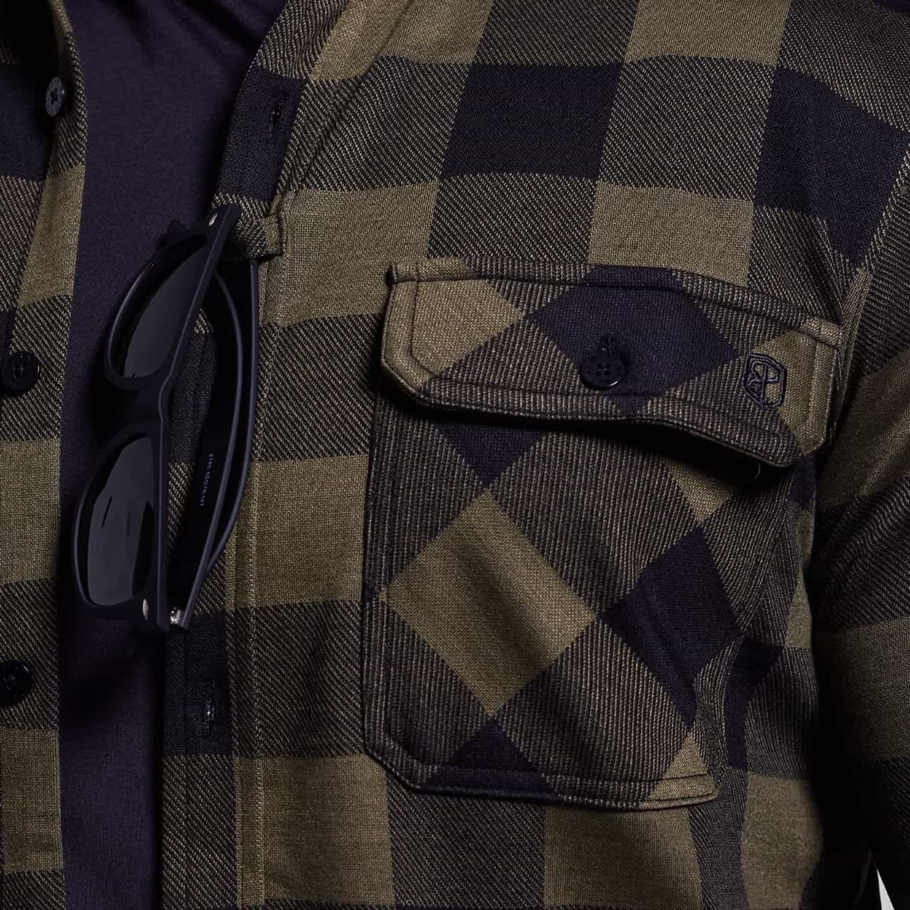 Close-up of a plaid shirt with sunglasses on a shoulder