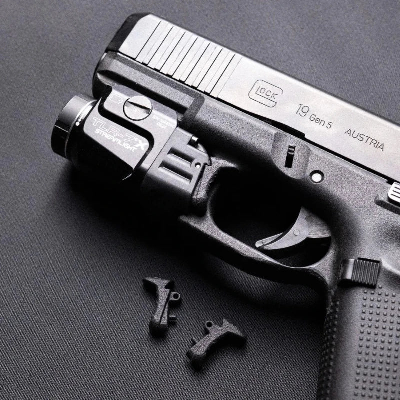 Kolibri Works ČVIRIQ - Streamlight TLR-7 Switch Buttons on the table